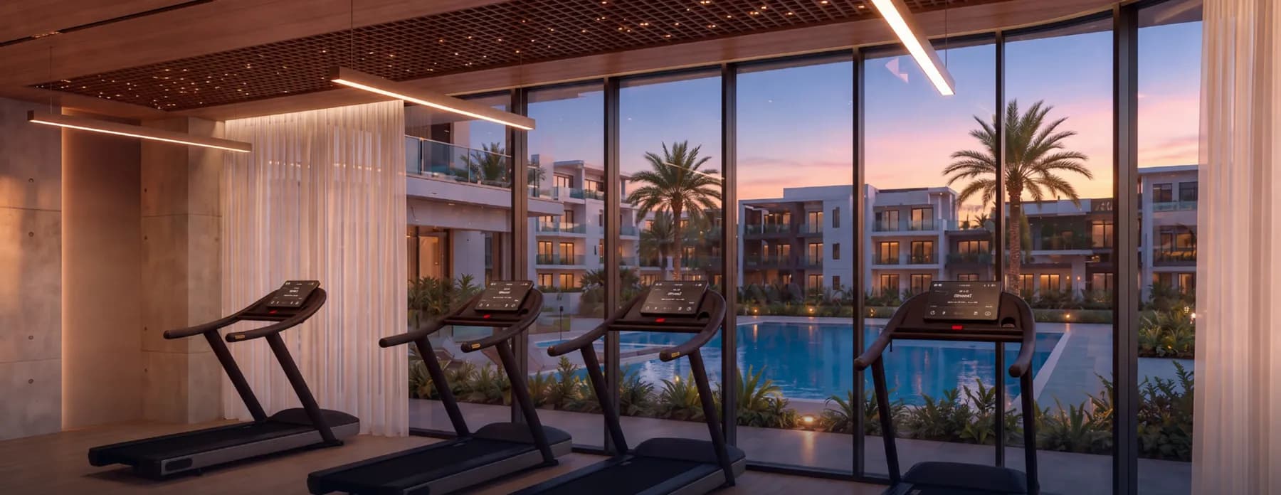 Indoor gym at Samana Portside overlooking the pool